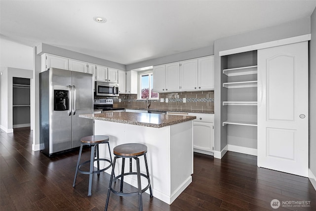kitchen with white cabinetry, dark wood-type flooring, and appliances with stainless steel finishes