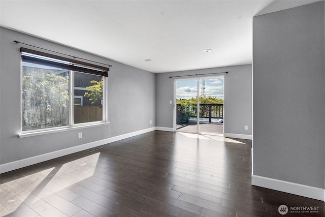 empty room featuring recessed lighting, visible vents, baseboards, and dark wood-style floors