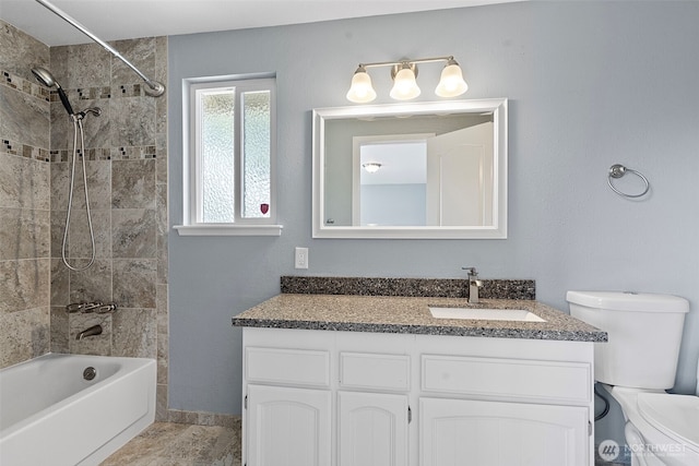 full bathroom with toilet, vanity, and washtub / shower combination