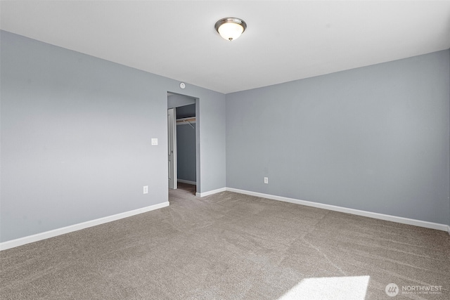 carpeted spare room with baseboards
