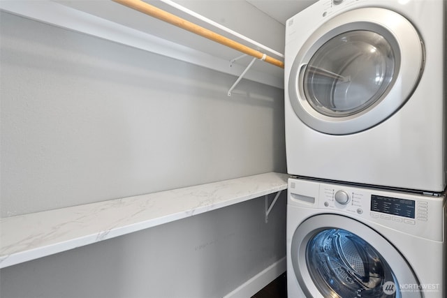 washroom with stacked washer and dryer and laundry area