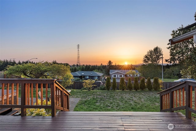 wooden deck featuring a fenced backyard and a yard
