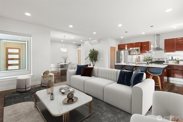 living area with visible vents, baseboards, dark wood-style floors, and recessed lighting
