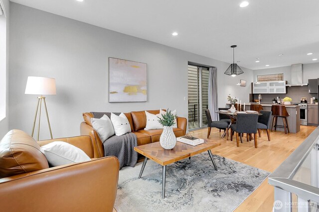 living room featuring light wood-type flooring and recessed lighting