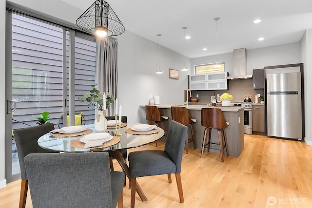 dining room featuring light wood-type flooring and recessed lighting