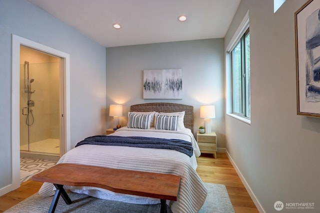 bedroom with light wood-style floors, baseboards, recessed lighting, and ensuite bath