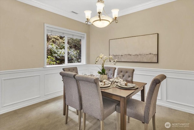 19017 5th St E, Lake Tapps, WA 98391 - dining space with a chandelier, carpet, a decorative wall, crown molding, and wainscoting
