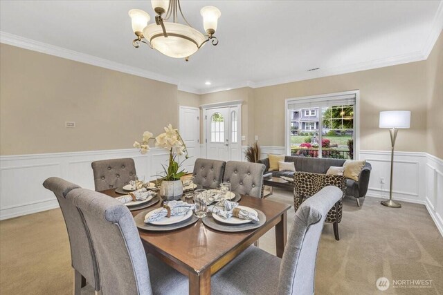 19017 5th St E, Lake Tapps, WA 98391 - dining area with light colored carpet, ornamental molding, a decorative wall, and a wainscoted wall