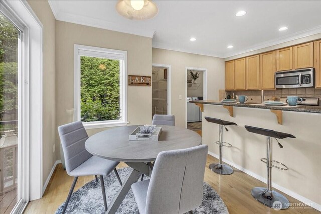 19017 5th St E, Lake Tapps, WA 98391 - dining space with light wood-style floors, baseboards, crown molding, recessed lighting, and washer / clothes dryer