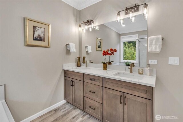 19017 5th St E, Lake Tapps, WA 98391 - bathroom with ornamental molding, baseboards, double vanity, and wood finished floors