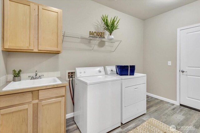 19017 5th St E, Lake Tapps, WA 98391 - washroom with washing machine and clothes dryer, cabinet space, light wood-style flooring, and baseboards