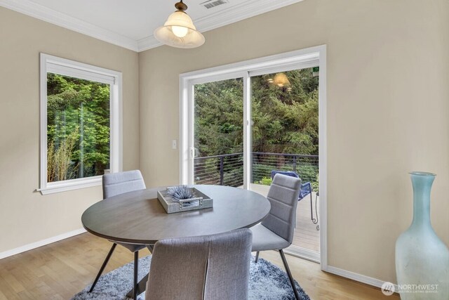 19017 5th St E, Lake Tapps, WA 98391 - dining space featuring plenty of natural light, baseboards, light wood finished floors, and ornamental molding