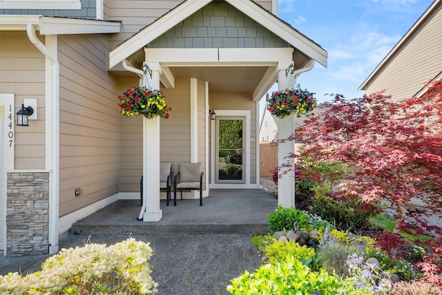 view of exterior entry with a porch