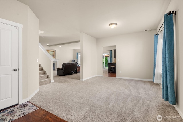 carpeted spare room with baseboards, stairs, and recessed lighting