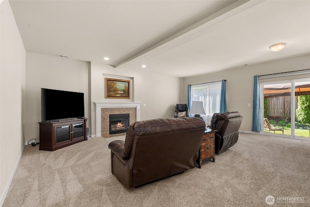 living room featuring carpet floors, a tiled fireplace, plenty of natural light, recessed lighting, and beam ceiling
