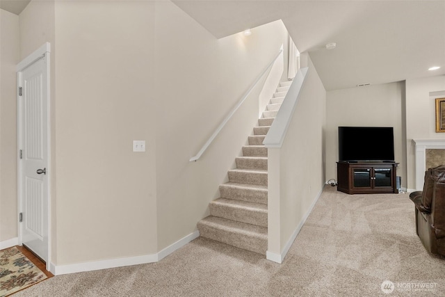 staircase featuring carpet flooring, baseboards, and recessed lighting