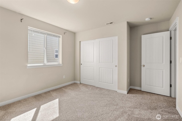 unfurnished bedroom featuring carpet flooring, a closet, and baseboards