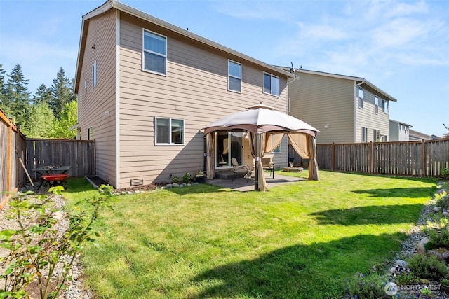 back of property featuring a gazebo and a patio area