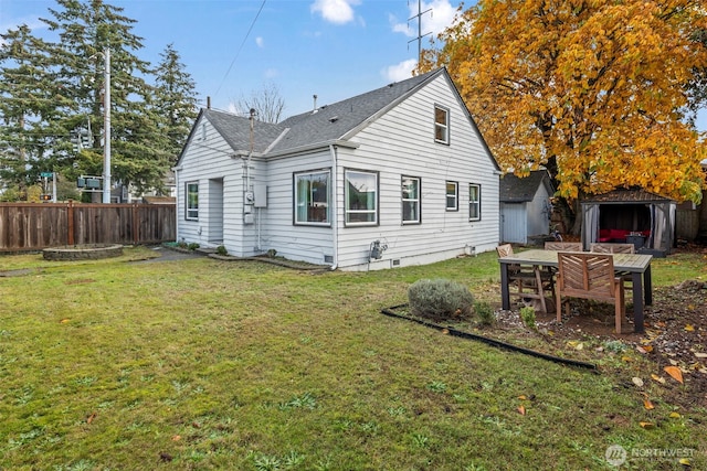 1921 N Stevens St, Tacoma, WA 98406 - back of house featuring fence, an outbuilding, a lawn, and roof with shingles
