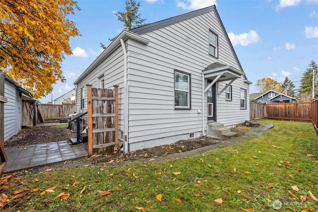 1921 N Stevens St, Tacoma, WA 98406 - rear view of house with a lawn, a fenced backyard, and entry steps