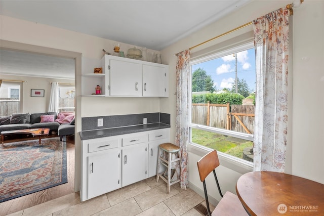 1921 N Stevens St, Tacoma, WA 98406 - kitchen featuring light tile patterned floors, dark countertops, open shelves, and white cabinetry