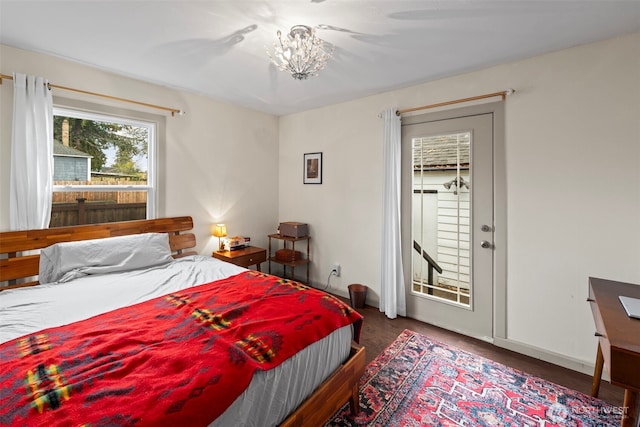 1921 N Stevens St, Tacoma, WA 98406 - bedroom featuring baseboards, an inviting chandelier, and wood finished floors