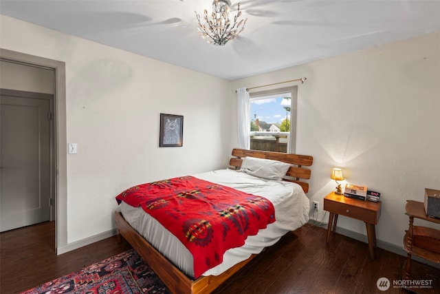 1921 N Stevens St, Tacoma, WA 98406 - bedroom with baseboards, wood finished floors, and a chandelier
