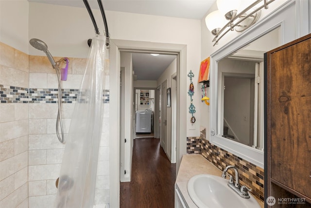 1921 N Stevens St, Tacoma, WA 98406 - full bathroom featuring vanity, decorative backsplash, tiled shower, and wood finished floors