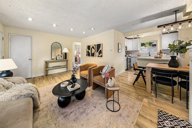 12910 6th Ave S, Burien, WA 98168 - living area featuring baseboards, recessed lighting, a textured ceiling, and light wood-style flooring