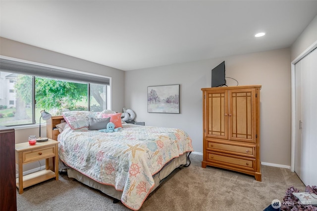 bedroom with recessed lighting, baseboards, a closet, and light carpet
