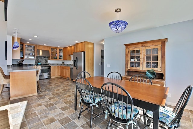 dining area with recessed lighting and stone finish flooring