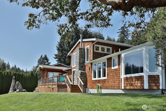 rear view of property with a yard and a wooden deck