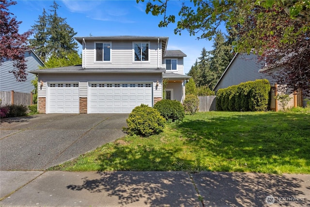 traditional-style home featuring fence, concrete driveway, stone siding, a front yard, and a garage