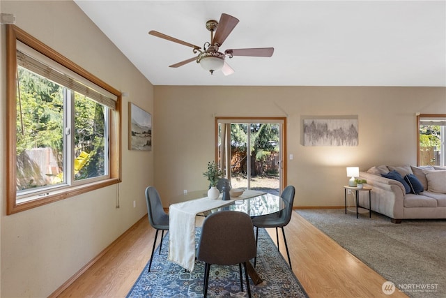 dining space with light wood finished floors, baseboards, and ceiling fan