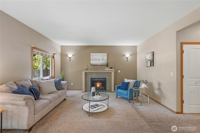 living area featuring a fireplace with flush hearth, carpet floors, and baseboards