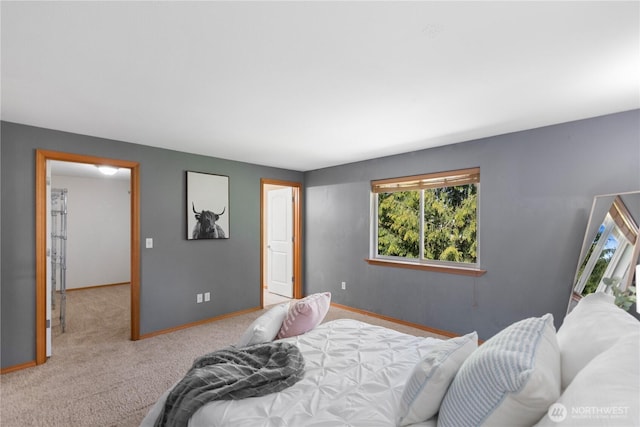 carpeted bedroom with baseboards and multiple windows