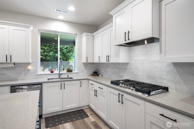 8852 N 5th St, Ridgefield, WA 98642 - kitchen featuring a sink, white cabinets, visible vents, and appliances with stainless steel finishes