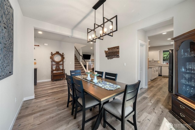 8852 N 5th St, Ridgefield, WA 98642 - dining room featuring a notable chandelier, recessed lighting, baseboards, light wood finished floors, and stairs