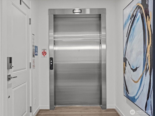 15528 NE 15th Pl Unit 201, Bellevue, WA 98007 - elevator with wood finished floors and baseboards
