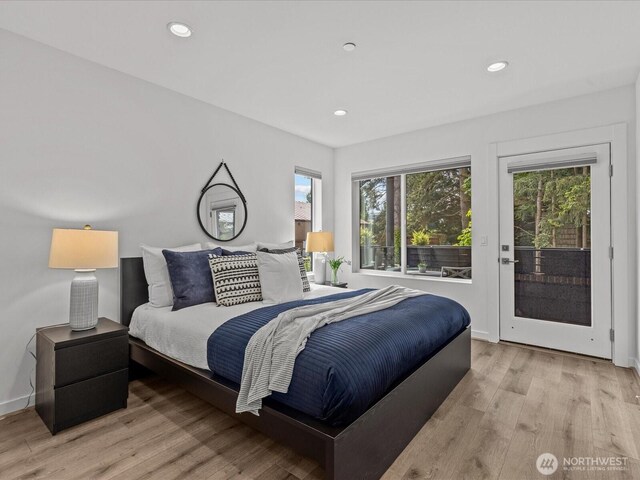 15528 NE 15th Pl Unit 201, Bellevue, WA 98007 - bedroom with access to outside, light wood-type flooring, recessed lighting, and baseboards