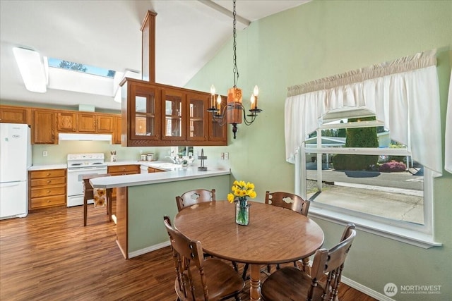23825 15th Ave SE Unit 180, Bothell, WA 98021 - dining space featuring high vaulted ceiling, a notable chandelier, dark wood-type flooring, and a skylight