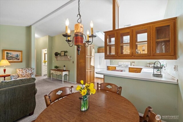 23825 15th Ave SE Unit 180, Bothell, WA 98021 - dining room featuring light colored carpet, a chandelier, beamed ceiling, and high vaulted ceiling