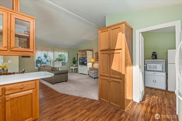 23825 15th Ave SE Unit 180, Bothell, WA 98021 - kitchen featuring dark wood-style flooring, open floor plan, vaulted ceiling, glass insert cabinets, and white appliances