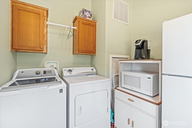 23825 15th Ave SE Unit 180, Bothell, WA 98021 - laundry room featuring washer and dryer, cabinet space, and visible vents