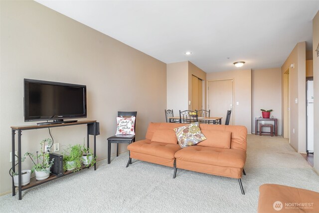 living area with baseboards and carpet flooring