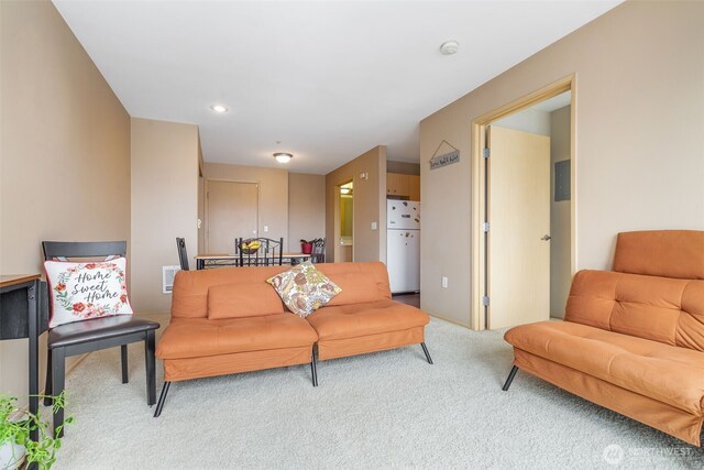 carpeted living area featuring visible vents