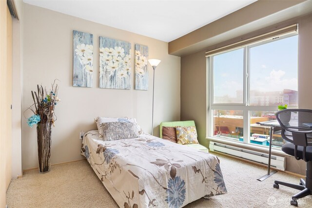 bedroom featuring carpet floors, baseboards, and a baseboard heating unit