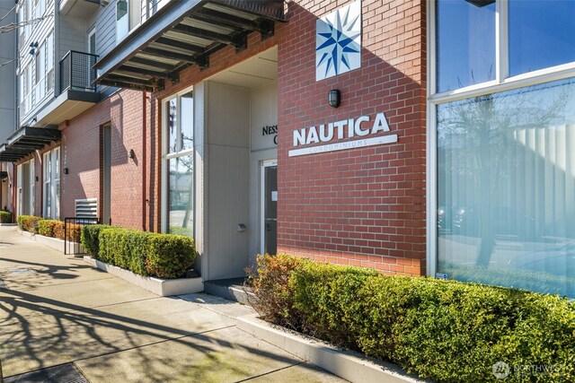 entrance to property featuring brick siding