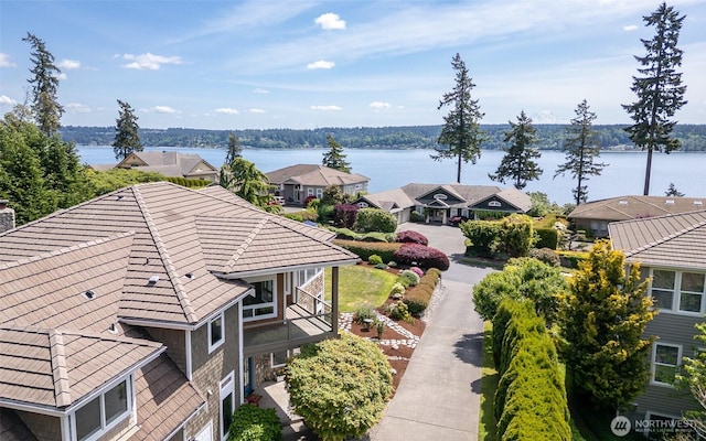 aerial view of residential area featuring a large body of water