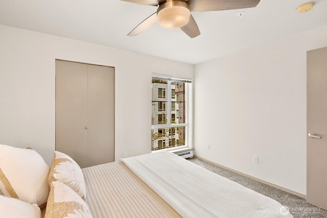 323 Queen Anne Ave N Unit 508, Seattle, WA 98109 - bedroom featuring baseboard heating, carpet, a ceiling fan, baseboards, and a closet